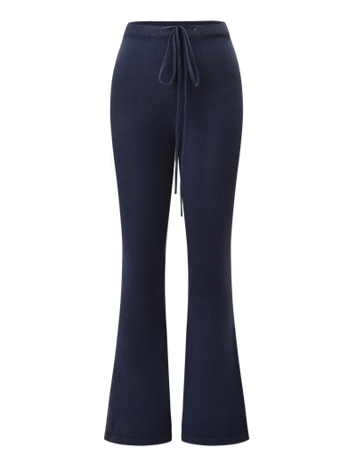 The LEORA PANT - NAVY by TIGERMIST is a relaxed-fit knit pant with a drawstring waist and slightly flared legs, shown on a white background.