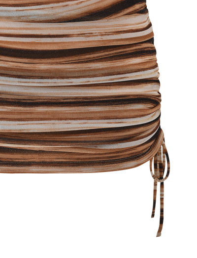 Close-up of the TIGERMIST BRAELYN MINI SKIRT - BROWN STRIPE, a ruched mini skirt with horizontal brown, beige, and black stripes and a sparkly drawstring detail at the right hem.