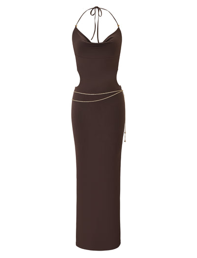 The SURIYA MAXI DRESS in chocolate brown by TIGERMIST is a sleeveless, floor-length cowl neck dress with adjustable halter straps, open back, and a gold waist chain for an elegant look.