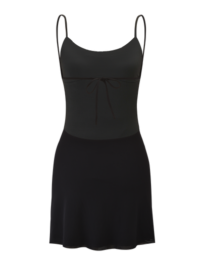 The ELYSIUM MINI DRESS - BLACK by TIGERMIST is a sleeveless mesh mini dress with thin straps, fitted bodice featuring a front bow tie, open back, and a slightly flared skirt. Shown against a plain background.