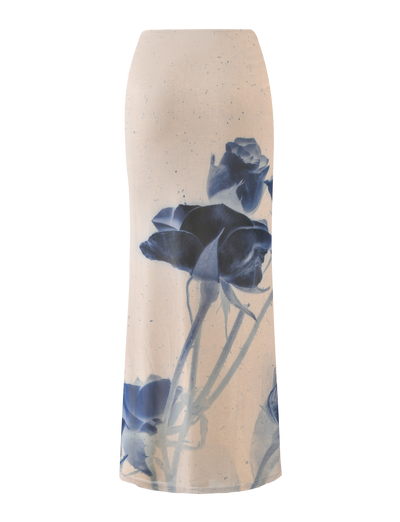The JANIS MAXI SKIRT by TIGERMIST features a bold indigo floral print with large blue roses, stems, and leaves on white fabric.