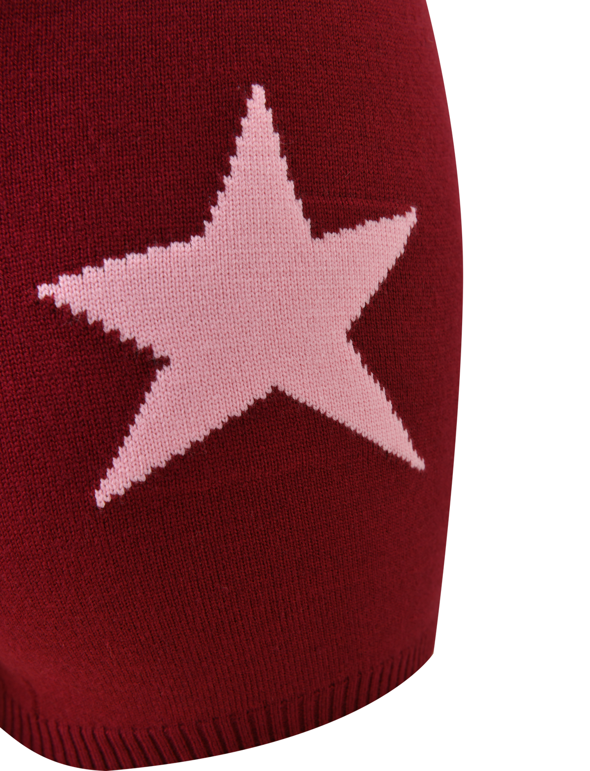 Close-up of the TIGERMIST ROUX SHORT in red, showcasing a maroon knit fabric with an asymmetrical star graphic at the center. The plain background emphasizes the texture and bold design.