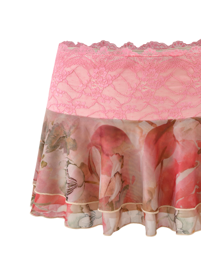 The TIGERMIST DUNE MESH MINI SKIRT - WATERCOLOUR FLORAL features a pink lace waistband, scalloped edging, and a sheer, flowing floral-patterned lower section.