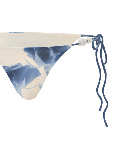 A close-up of the TIGERMIST CYLAS BIKINI BOTTOM in Indigo Floral, featuring blue and white rose print on the left side, set against a white background.
