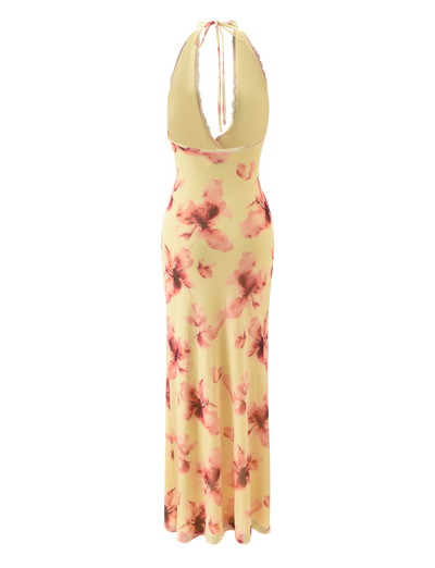 The ALLEGRA MAXI DRESS by TIGERMIST features a sleeveless, plunging halter design in yellow watercolour floral, with a low back and high leg split.