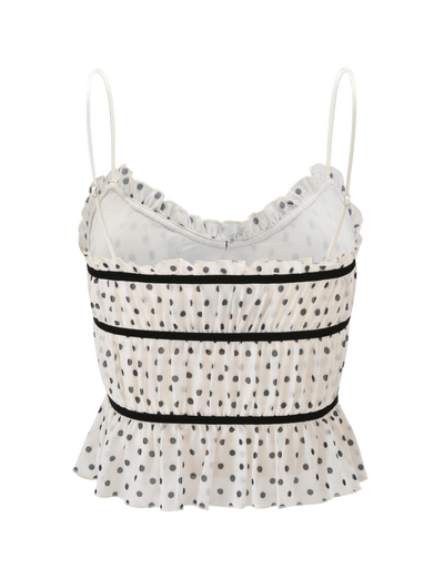 The LIORA TOP - POLKA DOT by TIGERMIST is a playful cropped cami with white polka dots, thin spaghetti straps, ruffled trim on the neckline and hem, and horizontal black bands across the front.