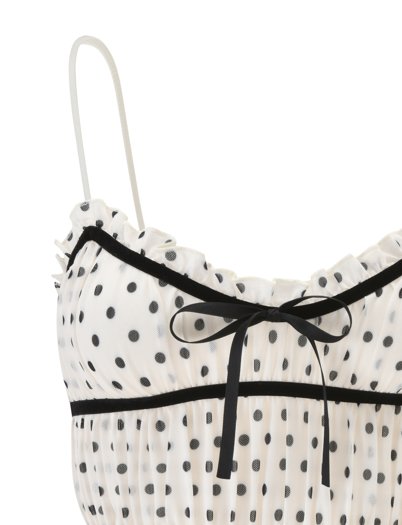 Close-up of the TIGERMIST LIORA TOP - POLKA DOT, featuring a white sheer fabric with polka dots, ruffled trim, thin adjustable straps, and a small black ribbon bow at the neckline.