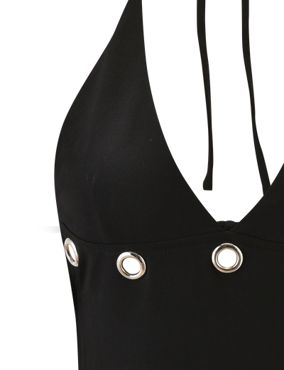 Close-up of the TIGERMIST MARREN TOP - BLACK, a chic backless halter neck top featuring silver eyelets along the chest and two thin black straps, displayed against a white background.
