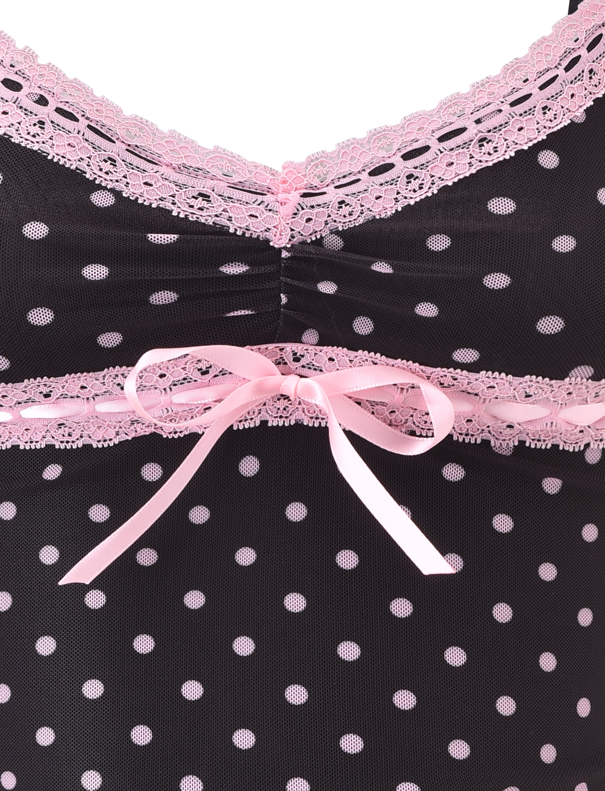 Close-up of the AMARA TOP - BLACK by TIGERMIST, featuring black fabric with polka dots, pink lace trim, and a pink ribbon bow at the center.
