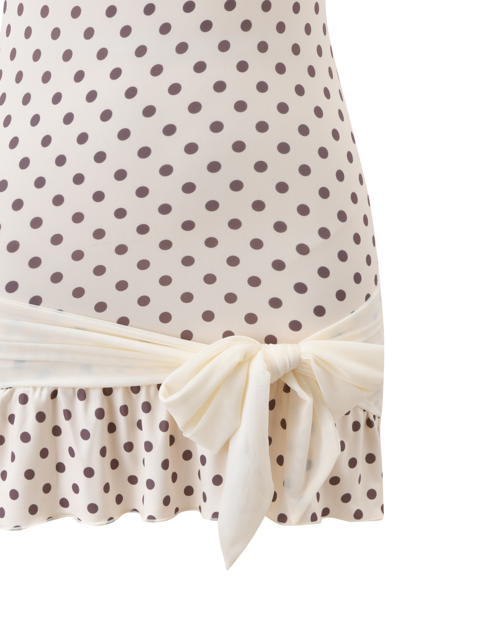 Close-up of the TIGERMIST TOVE MINI DRESS in white polka dot, showcasing its strapless design, wide sash at the waist, and playful ruffle hem.