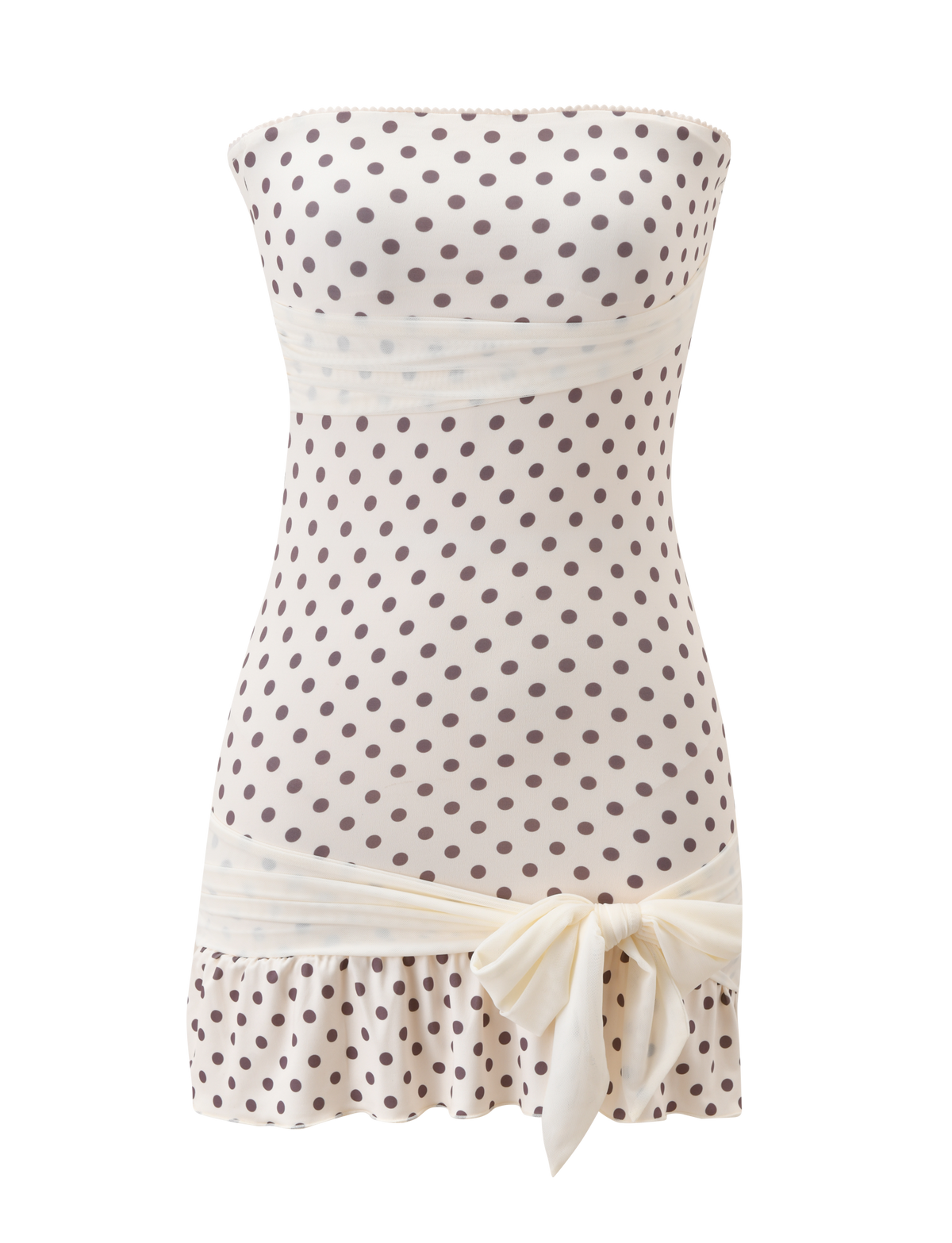 The TOVE MINI DRESS by TIGERMIST features a strapless white bodycon silhouette with brown polka dots, a ruched waist, playful ruffle hem, and a large cream bow at the hip. Displayed on a white background.