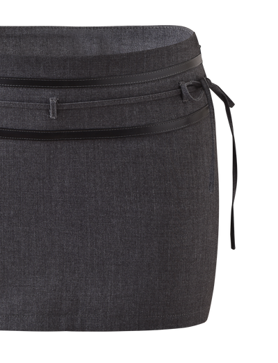 The FEDRA SKORT - GREY by TIGERMIST is a dark gray mini skort with subtle texture, a double waistband, black leather trim at the waist, and a thin black tie on the right side.