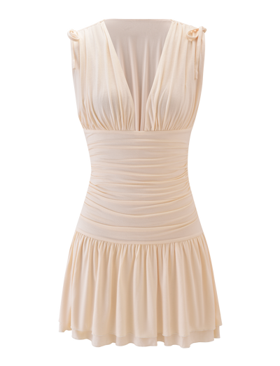 The HALONA MINI DRESS by TIGERMIST is a cream sleeveless mini with a deep V-neckline, gathered shoulders with tie details, an adjustable drawstring waist, and a flared ruffled skirt, shown on a plain white background.