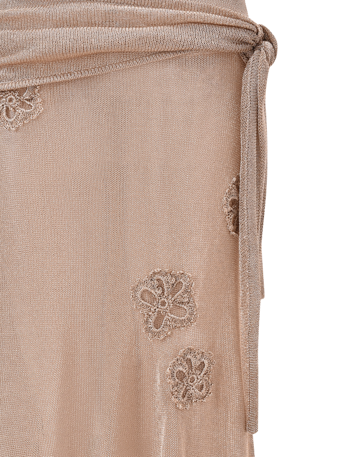 Close-up of a sheer, light beige fabric with embroidered florals and a tied waist, perfect to pair with the TIGERMIST ISATANA SKIRT - GOLD for an elegant look or styled with an asymmetrical skirt for added sophistication.