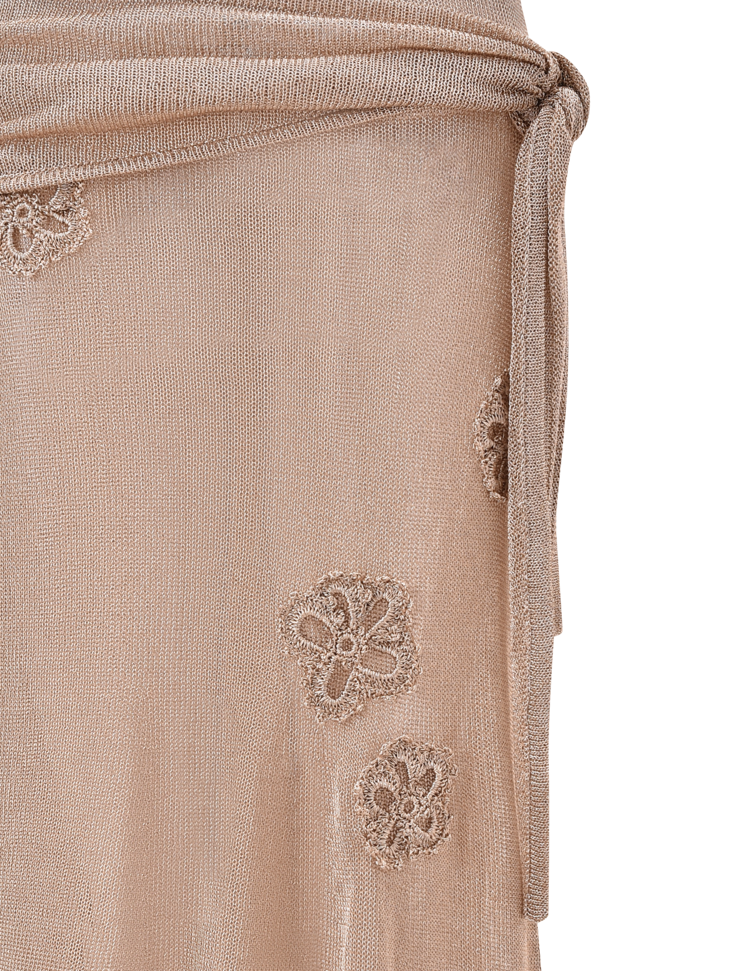 Close-up of a sheer, light beige fabric with embroidered florals and a tied waist, perfect to pair with the TIGERMIST ISATANA SKIRT - GOLD for an elegant look or styled with an asymmetrical skirt for added sophistication.