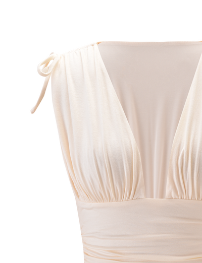 Close-up of the HALONA TOP - CREAM by TIGERMIST, featuring a sleeveless design with a plunging bodice, gathered bust, sheer mesh chest panel, and chic adjustable shoulder ties.