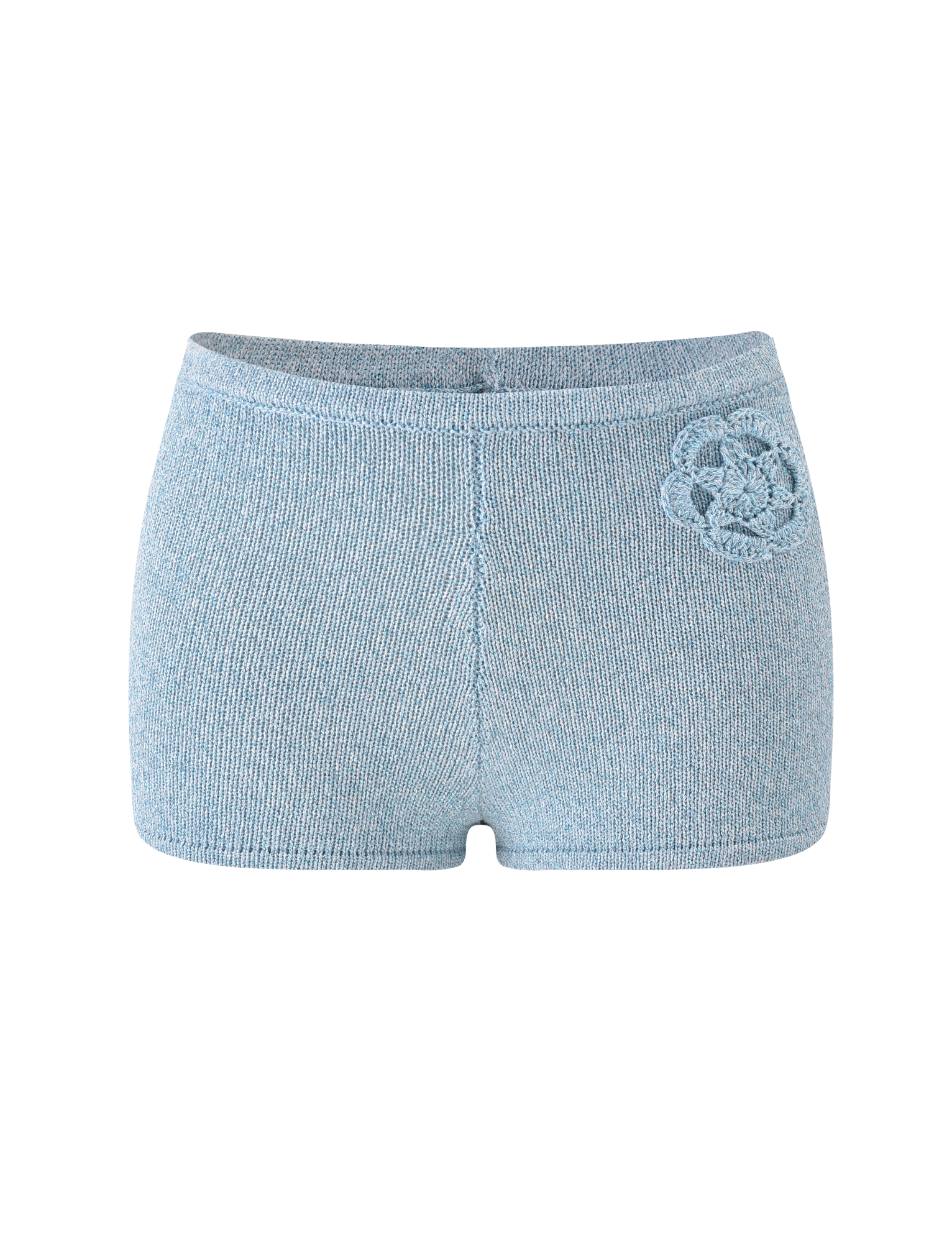 The SUNIA SHORT - BLUE by TIGERMIST are light blue ultra-mini fitted shorts with a decorative crocheted flower appliqué on the left hip, shown against a plain white background.