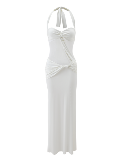 The DAPHNIA DRESS - IVORY by TIGERMIST features a halter-neck, knotted bust detail, ruched sides, and a fitted hourglass silhouette. Its smooth fabric and minimalist design offer an elegant, flowing look.