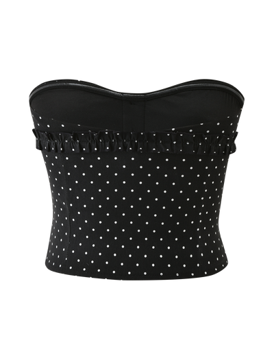 The KITTIE STRAPLESS CORSET - BLACK DOT by TIGERMIST features a black, strapless design with white polka dots, ruffle detail along the top edge, a fitted silhouette, and sweetheart neckline. Displayed on a plain white background.