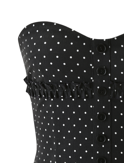 Close-up of the KITTIE STRAPLESS CORSET - BLACK DOT by TIGERMIST, featuring a strapless polka dot design, sweetheart neckline, black front buttons, and a ruffled detail across the chest.