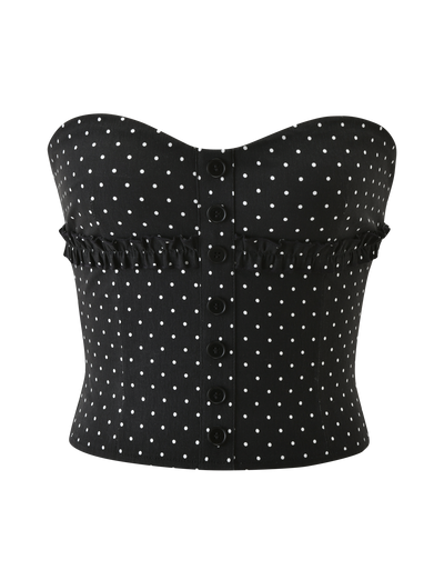 The KITTIE STRAPLESS CORSET - BLACK DOT by TIGERMIST is a strapless corset in stretch suiting fabric with polka dots, front button closures, and a ruffled trim across the chest.
