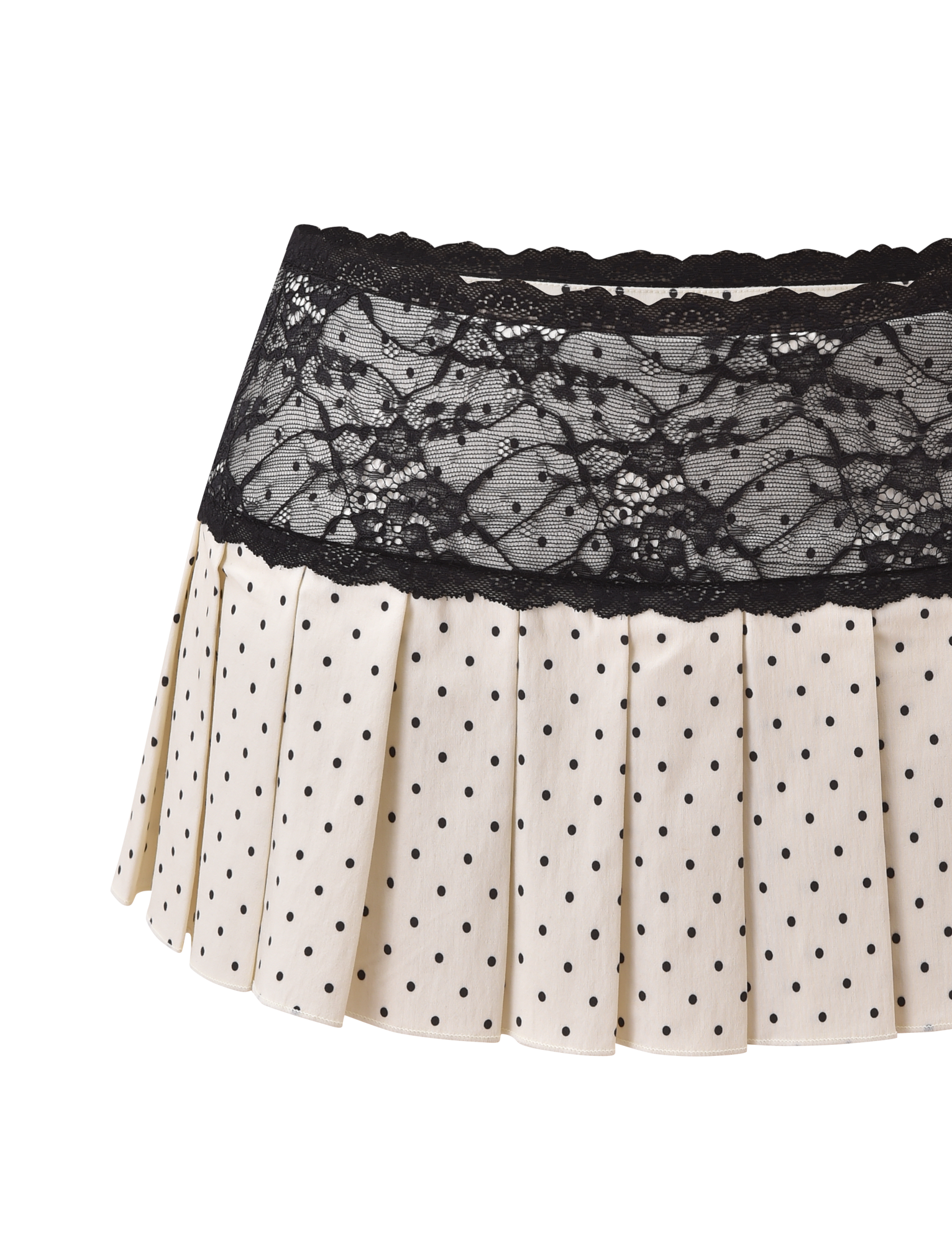 The TIGERMIST KITTIE LACE SKORT - CREAM DOT is a cream pleated mini skort with black polka dots and a wide black lace waistband, shown against a white background.