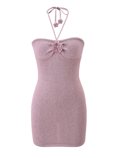 The SUNIA DRESS by TIGERMIST is a sleeveless baby pink knit mini dress featuring a halter neckline, rose appliqué at the bust, and a fitted silhouette.