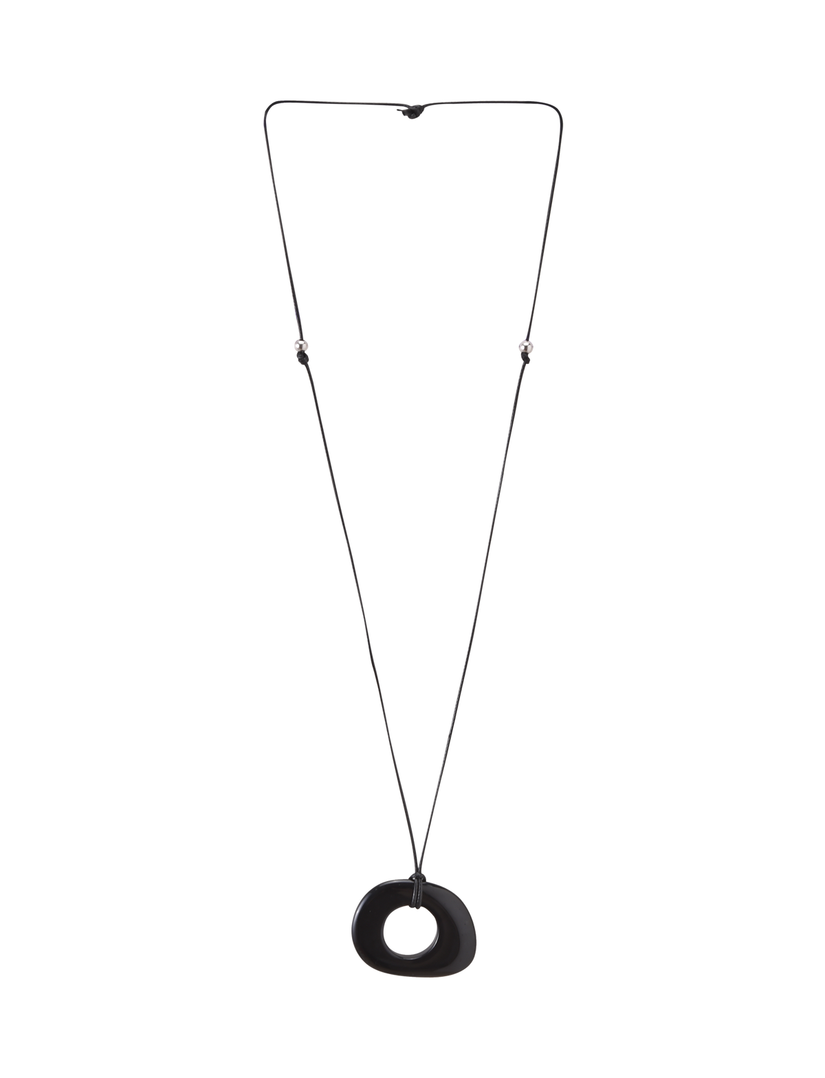 The FAELLA PENDANT NECKLACE - BLACK by TIGERMIST features a long, thin adjustable cord with two small beads and a large smooth black resin pendant with an off-center hole, shown against a plain white background.