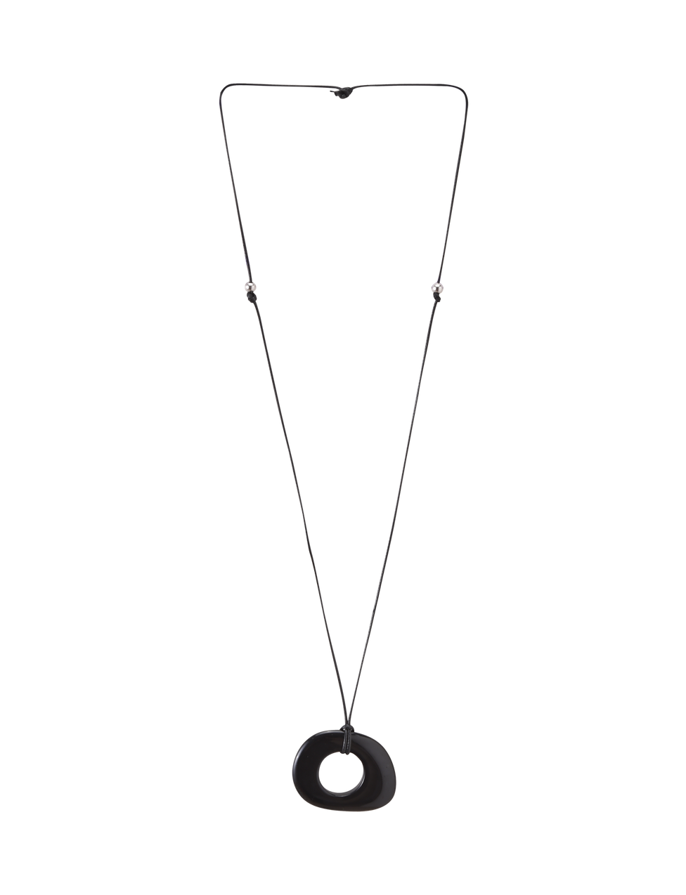 The FAELLA PENDANT NECKLACE - BLACK by TIGERMIST features a long, thin adjustable cord with two small beads and a large smooth black resin pendant with an off-center hole, shown against a plain white background.