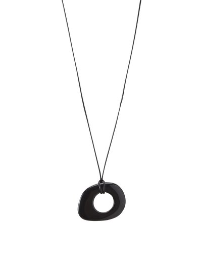 The FAELLA PENDANT NECKLACE - BLACK by TIGERMIST is a minimalist piece featuring a black cord and an asymmetrical, hollow oval resin pendant, shown against a plain white background.
