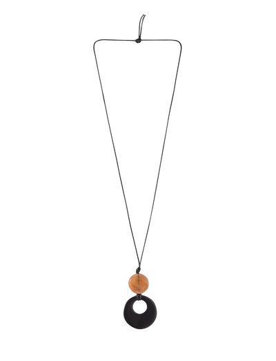 The BREYA PENDANT NECKLACE - TAN by TIGERMIST features a minimalist design with a thin black cord, a central round flat black resin pendant, and an oval wooden bead above it.
