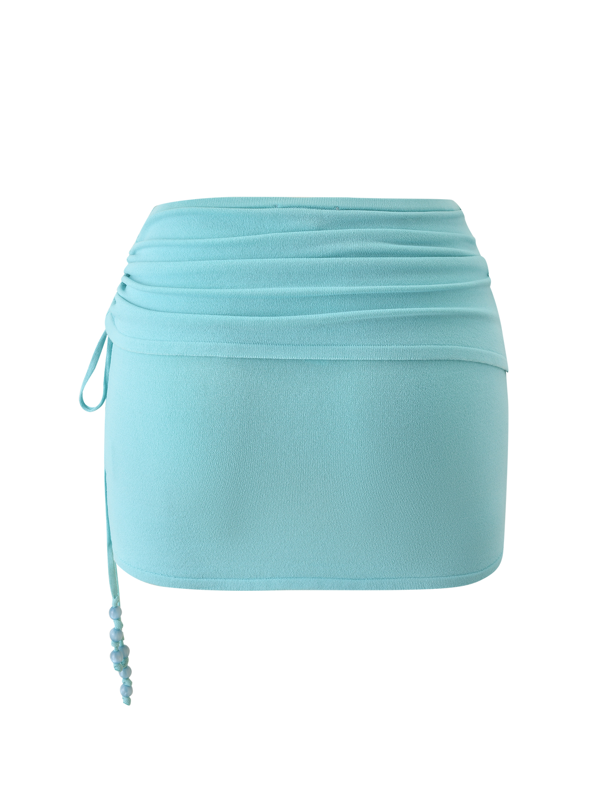 The JASMINA KNIT MINI SKIRT - BLUE by TIGERMIST features a light blue knit design with a draped ruched waistband and side drawstring detailed with small blue beads, shown against a white background.