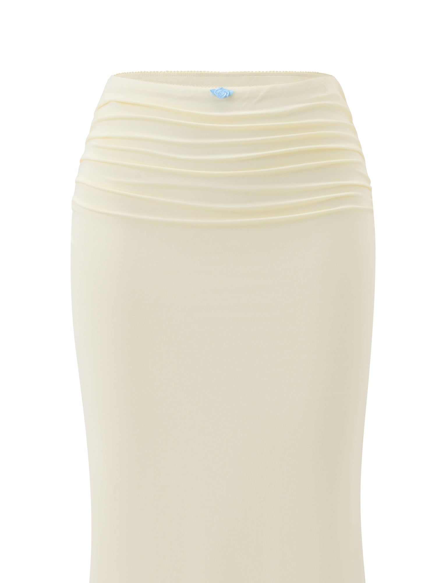 A close-up of the TIGERMIST CALINA LACE PANEL MIDI SKIRT in cream, featuring a ruched waist, horizontal pleats near the waistband, and a small blue decorative detail at the center top.