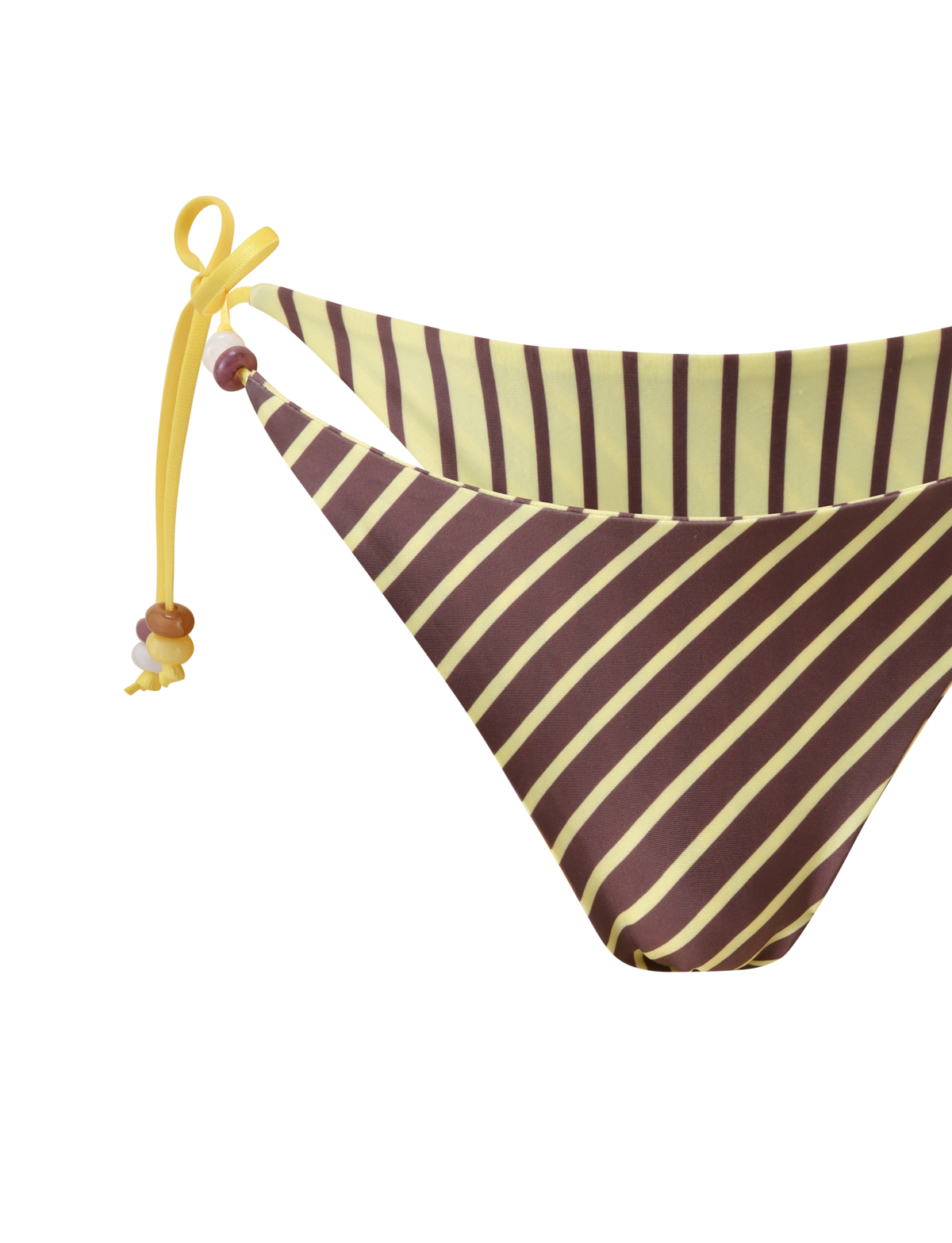 The FINLEA REVERSIBLE BIKINI BOTTOM by TIGERMIST features diagonal brown and yellow stripes, yellow side ties, and left-string beaded details, showcased in a close-up against a white background.