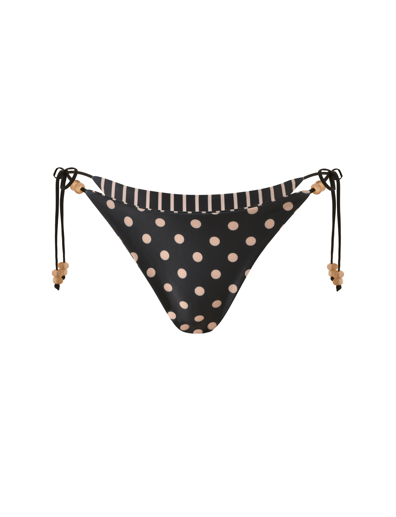 The FINLEA REVERSIBLE BIKINI BOTTOM by TIGERMIST features a black cheeky cut with light pink polka dots, a tan striped waistband, and adjustable beaded side ties, shown on a white background.
