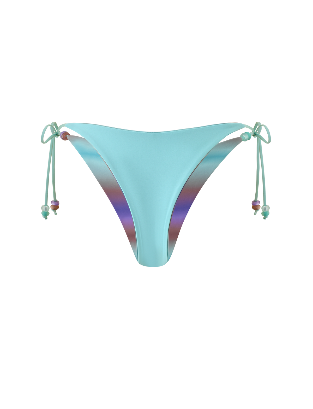 The TIGERMIST REVERSIBLE FINLEA BIKINI BOTTOM - MERMAID OMBRE STRIPE features a light blue cheeky cut with adjustable side ties embellished with colorful beads, displayed on a plain white background. The inner lining boasts a reversible design showcasing a vibrant multicolour mermaid ombre stripe with an iridescent gradient effect.