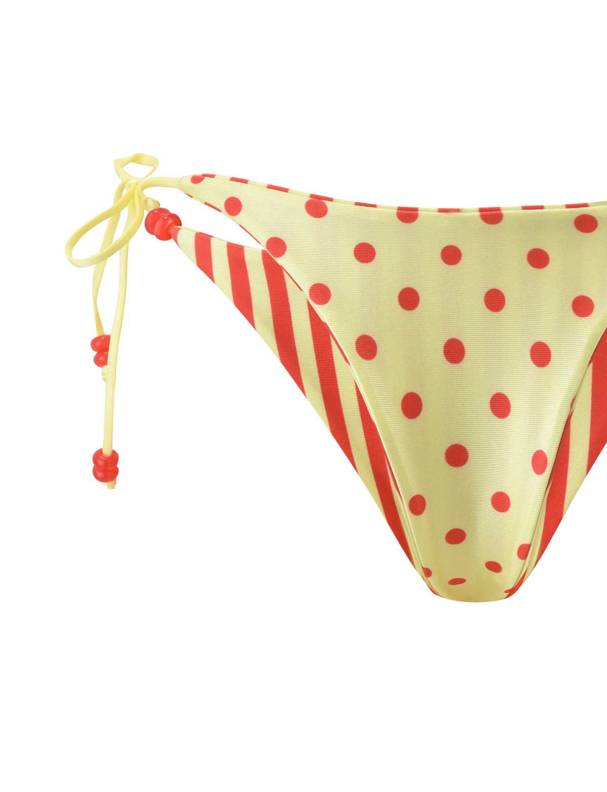 The TIGERMIST FINLEA REVERSIBLE BIKINI BOTTOM features a cheeky cut with red diagonal stripes, yellow polka dots, and yellow string ties with red beads on the left side. Displayed on a plain white background.