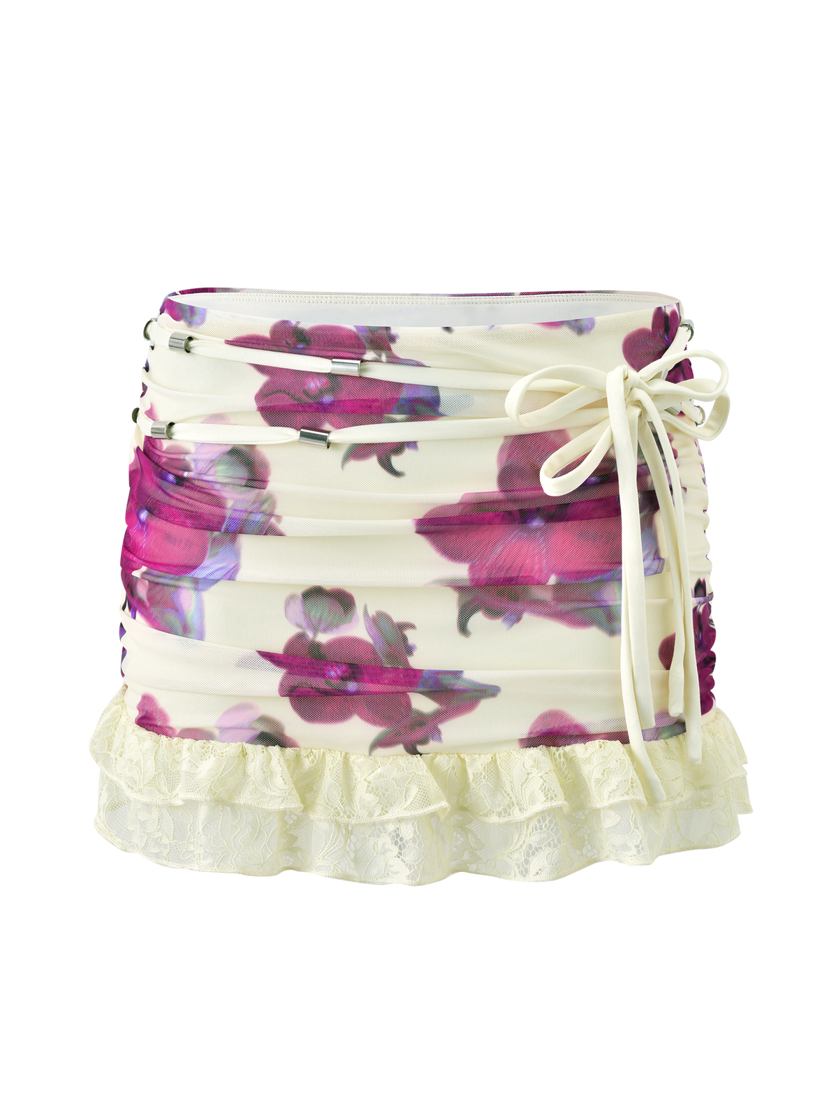 The LILIAH MINI SKIRT - ORCHID HAZE by TIGERMIST is a white floral mesh mini skirt with pink and purple orchid prints, ruched sides, a side-tie bow, and a cream lace ruffle hem.