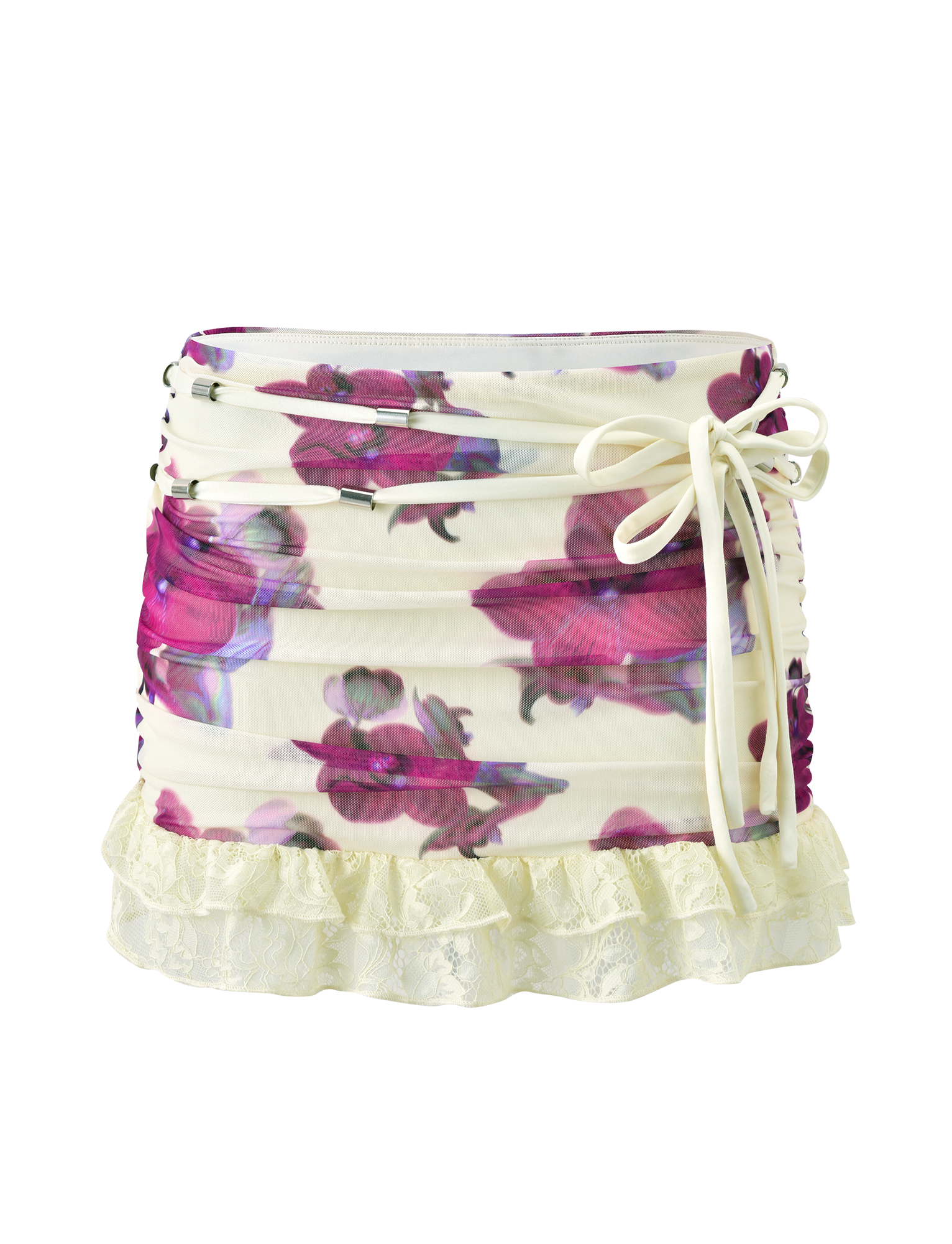 The LILIAH MINI SKIRT - ORCHID HAZE by TIGERMIST is a white floral mesh mini skirt with pink and purple orchid prints, ruched sides, a side-tie bow, and a cream lace ruffle hem.