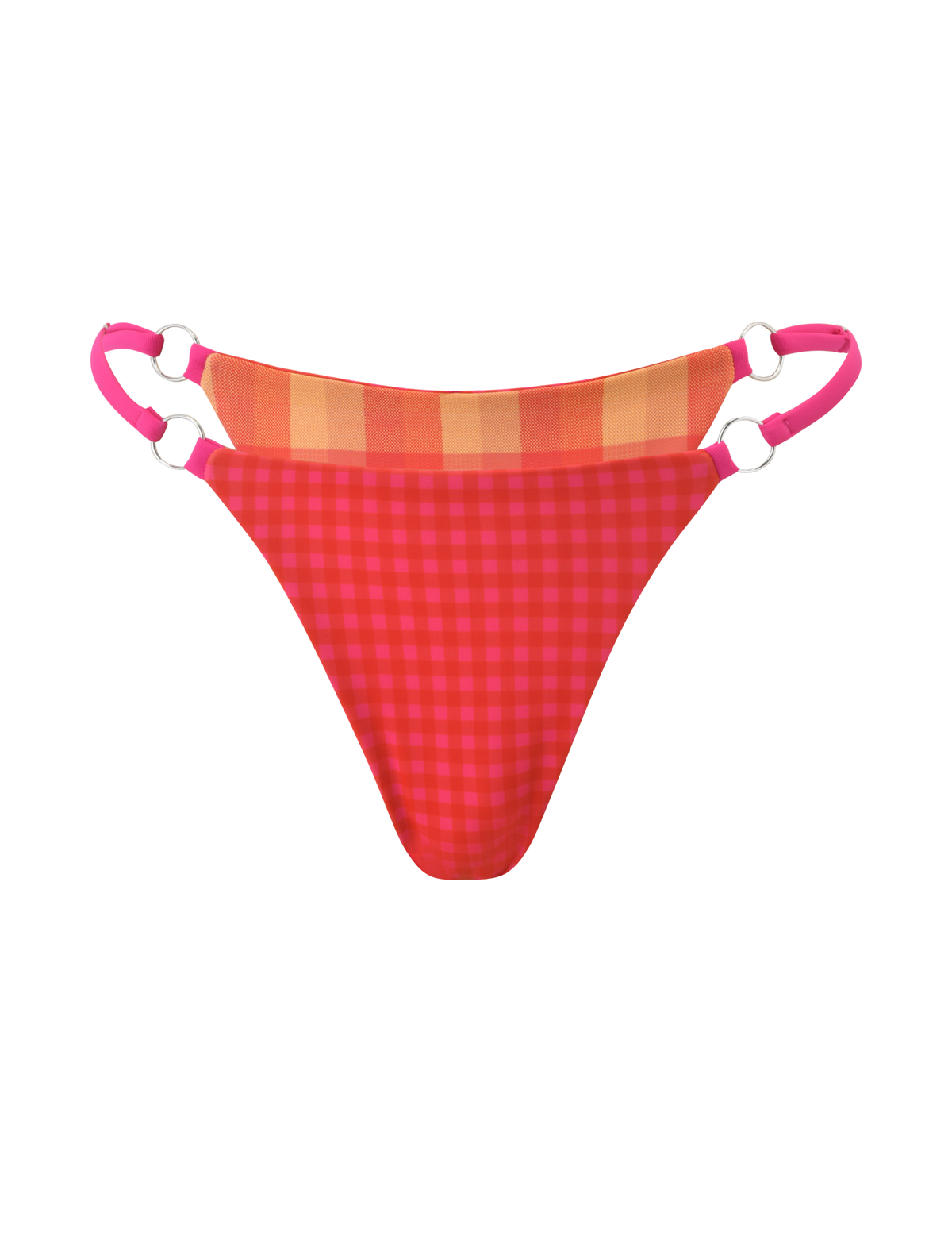 The AYANNA REVERSIBLE BIKINI BOTTOM by TIGERMIST pairs red and pink gingham with orange and yellow plaid accents, pink double adjustable side straps with silver rings, and cheeky coverage. Photographed on a plain white background.