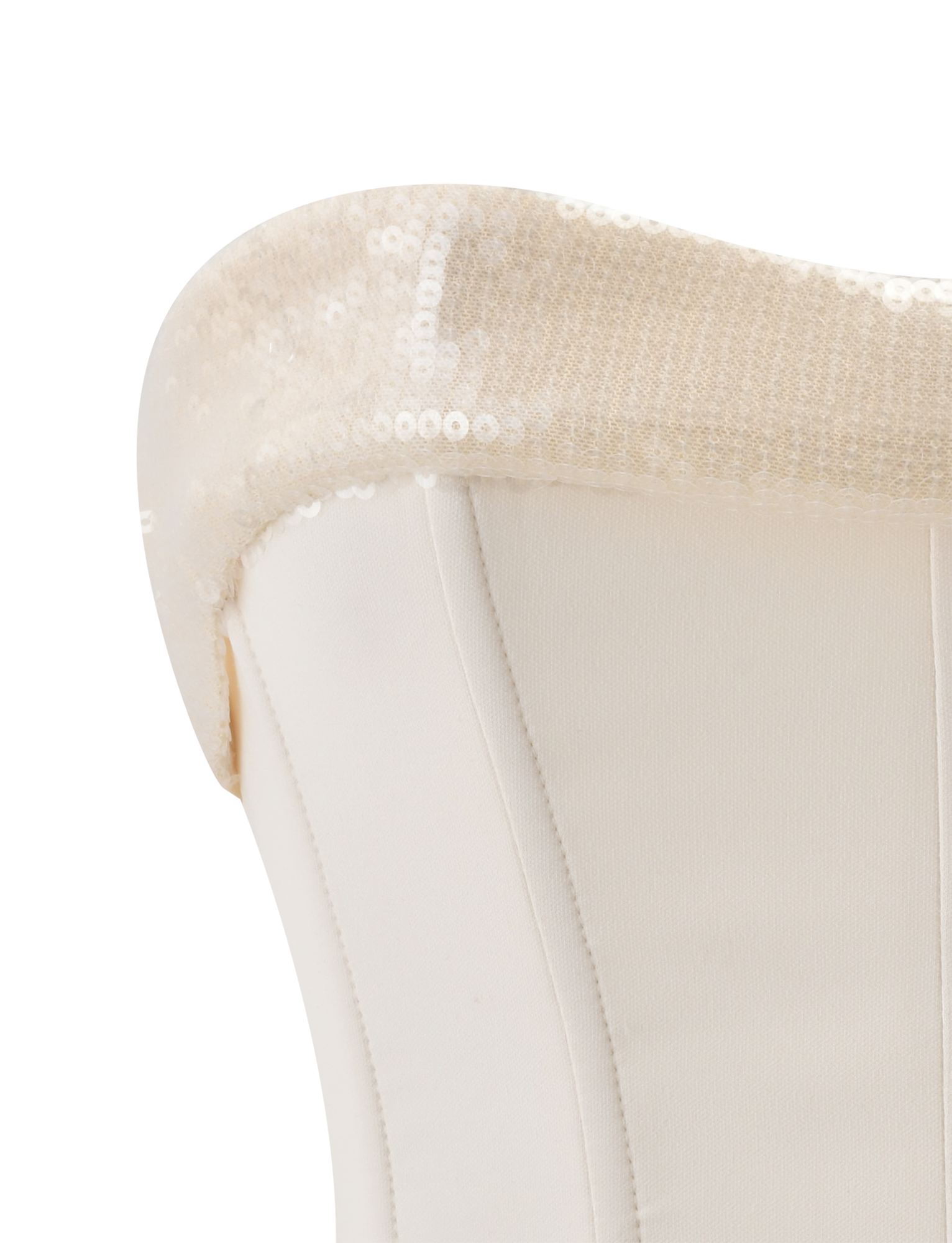 Close-up of the CHARLYZE BUSTIER in cream by TIGERMIST, showcasing its white fabric, curved bustier top reminiscent of a sweetheart neckline, and shimmering sequin panel on the back.