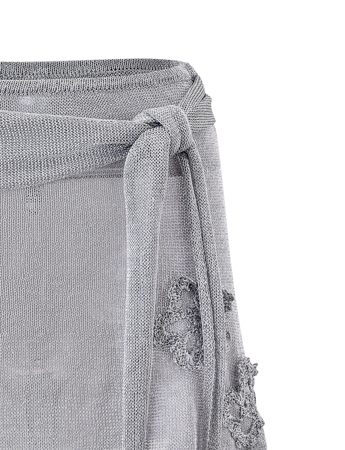 Close-up of the TIGERMIST ISATANA MINI SKIRT in silver, featuring a metallic knit, tied belt, and distressed details with frayed holes and loose threads, shown against a plain white background.