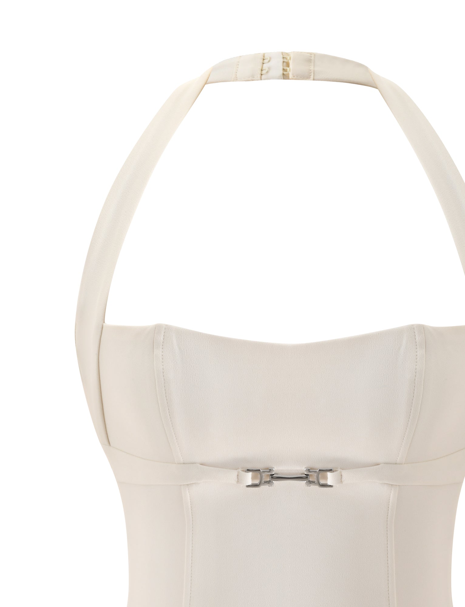 Close-up of the TIGERMIST KITTIE BUCKLE TOP in cream, featuring a structured bodice inspired by a corset and finished with a silver buckle detail at the waist, shown against a plain white background.