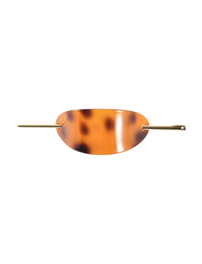 The TIGERMIST RUKA BARETTE - TORTOISESHELL is an oval, acrylic tortoiseshell hair clip with a stylish gold bar closure threaded through side openings, shown against a plain white background.