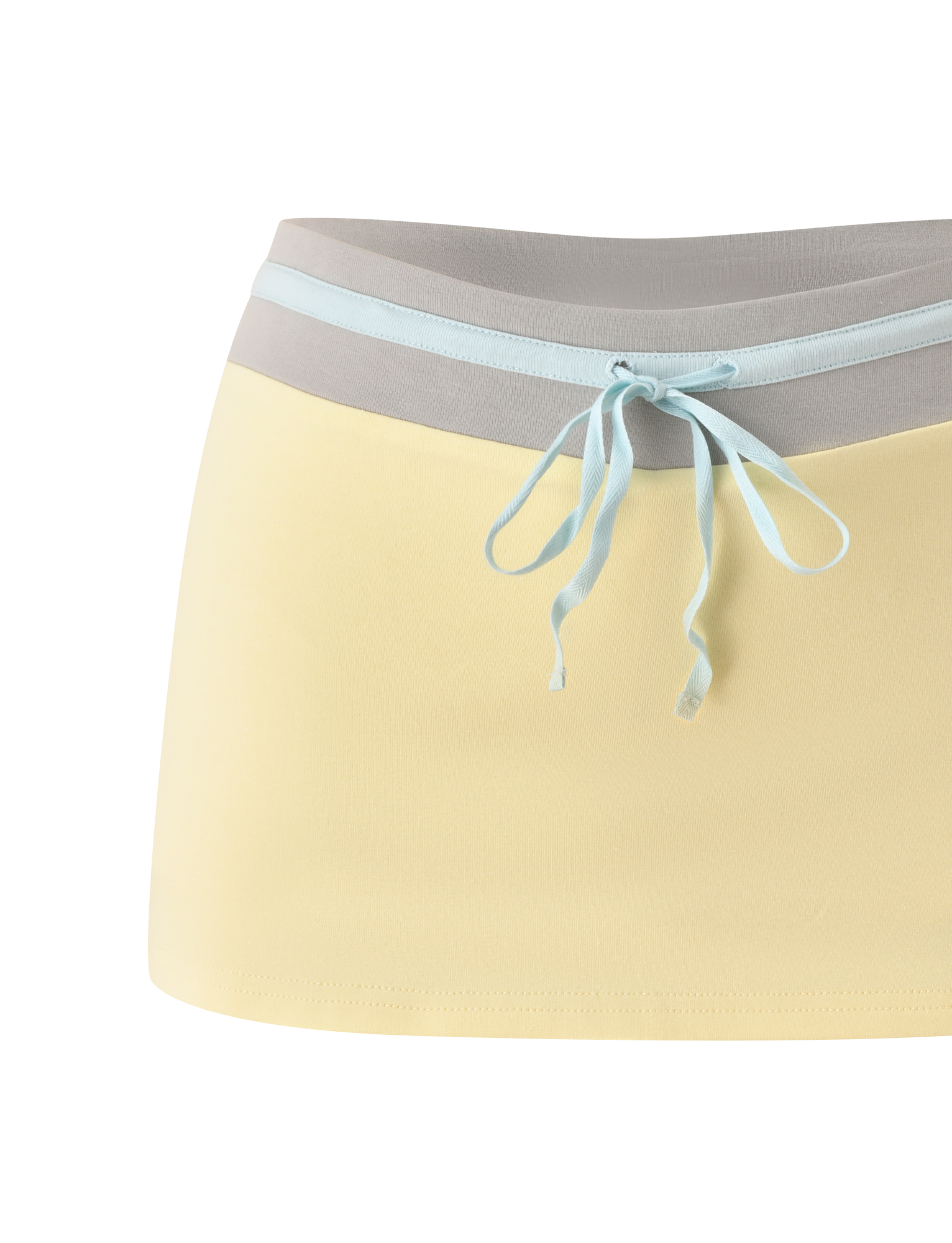 The TIGERMIST COLLINS SKORT - BUTTER features a pale yellow body, light gray wide waistband, and light blue ribbon tie, blending the playful look of a mini skirt with the comfort of mini shorts.