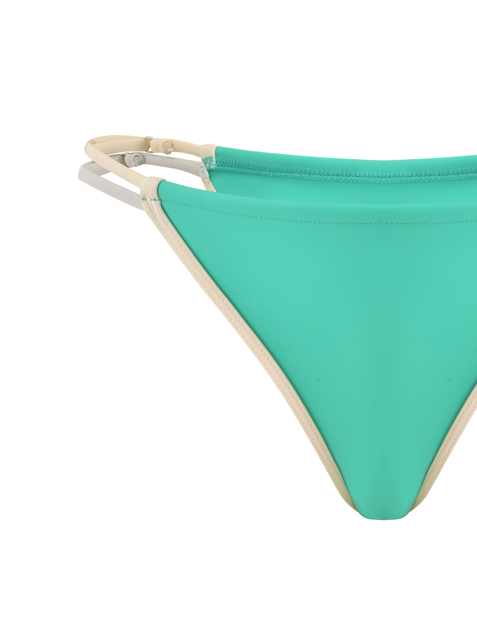 Close-up of the TIGERMIST JACE BIKINI BOTTOM in Kelly Green with beige trim and double side straps, featuring a low-rise super cheeky cut, displayed against a white background.
