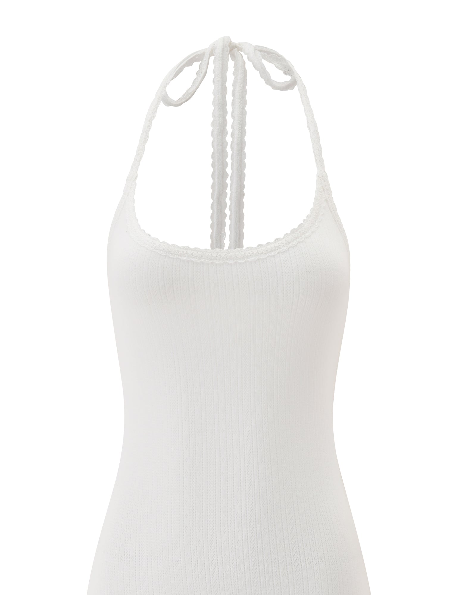 The TIPPI MINI DRESS - WHITE by TIGERMIST is a white ribbed mini dress featuring a halter neck with a tie at the back, a scoop neckline, and a fitted silhouette. The soft, slightly textured fabric is visible in the image, which displays only the upper portion of the dress.
