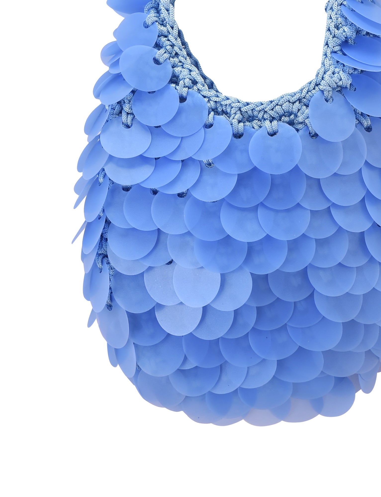 A close-up of the CLEO BAG - BRIGHT BLUE by TIGERMIST, featuring overlapping round plastic discs that create a textured, scale-like effect reminiscent of a sequin crochet bag.