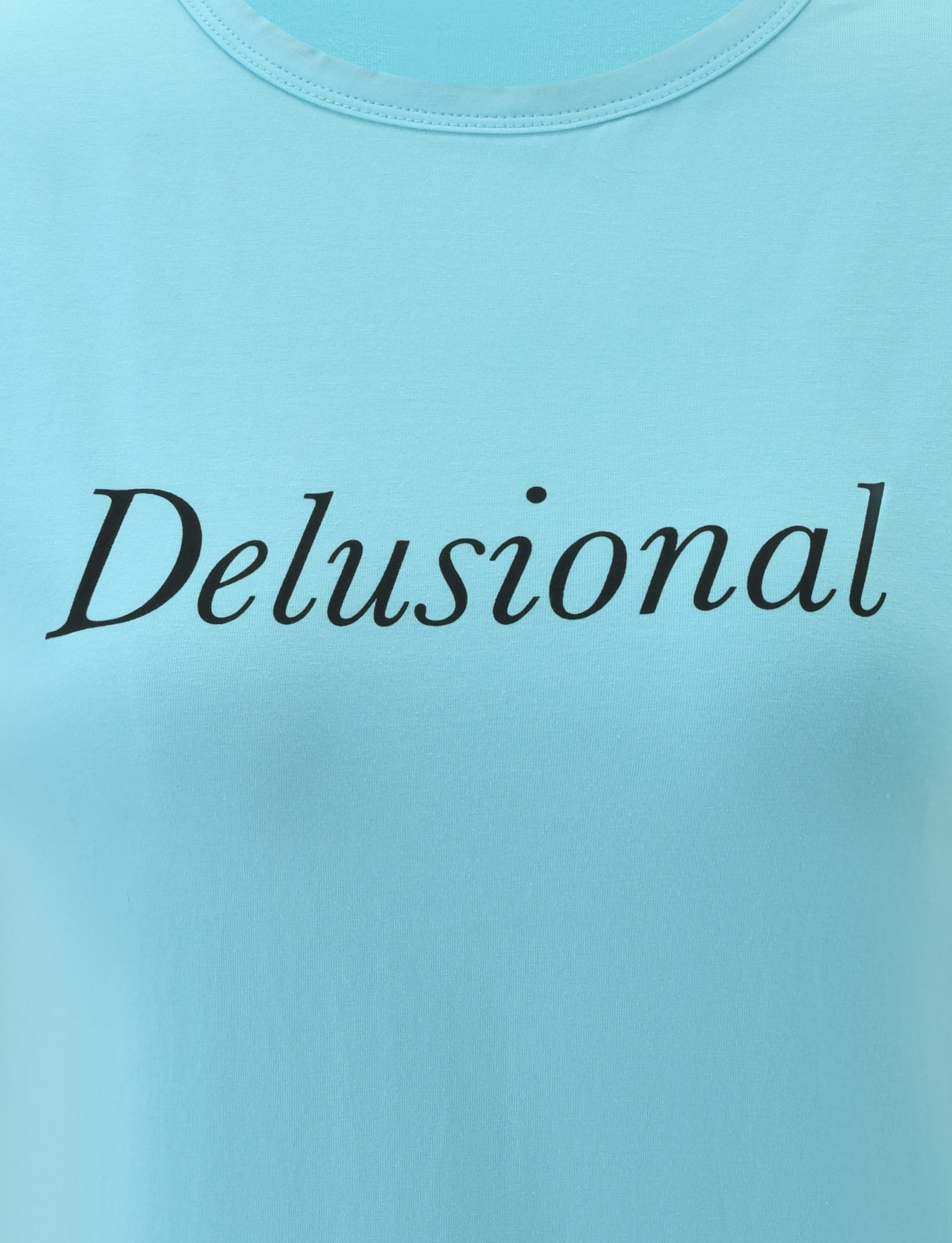 A turquoise DANIELLE TEE by TIGERMIST featuring the word “Delusional” printed across the chest in black, italicized font.