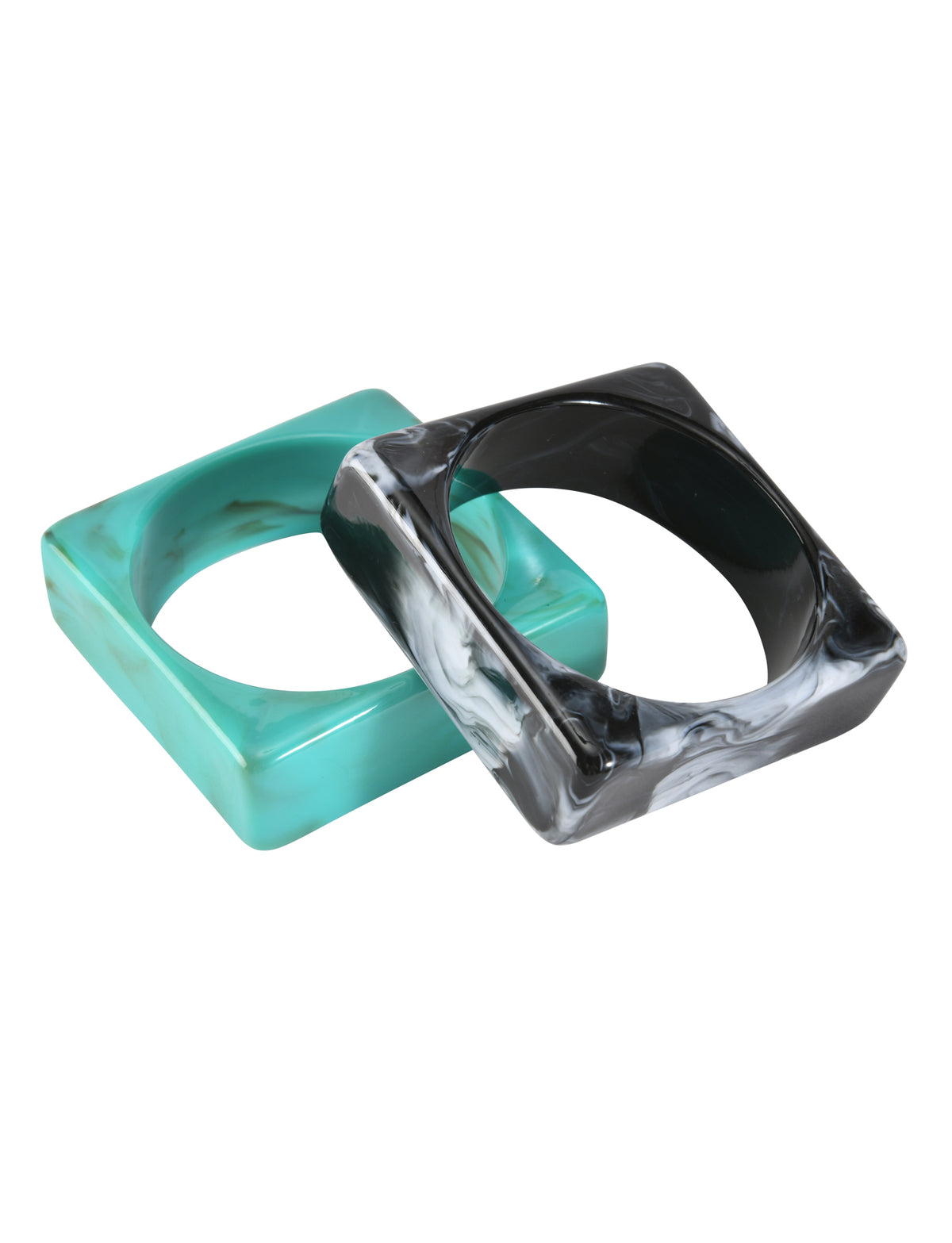 The AUGIE BANGLE SET - EMERALD AND BLACK by TIGERMIST features two bold, geometric acrylic bangles—one emerald and one black with a marble effect—overlapping on a white background for a striking look.